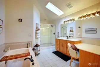 Glamorous ensuite bathroom, with double vanities, amazing lighting, and skylights.