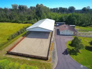 This showcases the high-end Riding Arena, fully equipped Barn, 3 Bay Storage Building, paved driveway, and manicured yard!