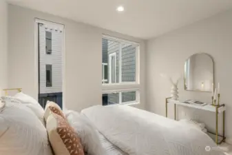 A touch of elegance meets simplicity in this bedroom corner. With ample natural light and a clean aesthetic, this room is ready to be styled to fit your unique taste, offering a peaceful sanctuary within the home.