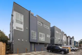 The modern exterior design complements private alley parking, offering convenience and security.