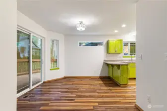 Dining area attached to kitchen opens up to large trex deck