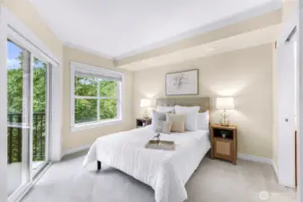 Light and bright primary bedroom with sliding door balcony access