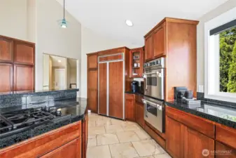 Chef's kitchen with gas cooktop and double oven.