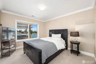 Lower level bedroom with views of the lake and hot tub.