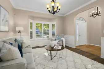 Versatile front room with bay window and wainscoting. Shown here as a sitting room but could easily serve as a formal dining space.