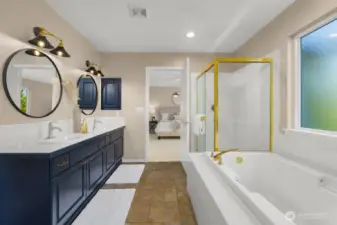 Ensuite bath with double vanity, soaking tub, separate shower, and modern lighting.