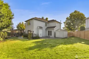 Large fully fenced backyard with mature landscaping for privacy.