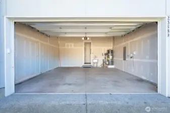 2-car garage with EV outlet/charger, storage, and utility sink.