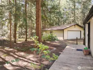 Detached garage is insulated with a paved path leading to the side door for accessing the bonus room.