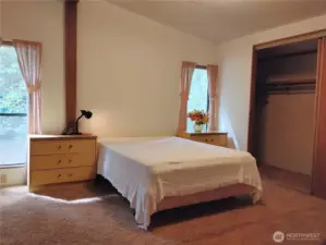 The primary bedroom has a wall of closets which are deep and can accomodate a few dressers.