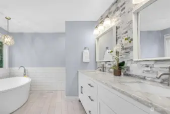 This dazzling bath, replete with a huge soaking tub and double sinks, create a very spa-like inviting feeling!