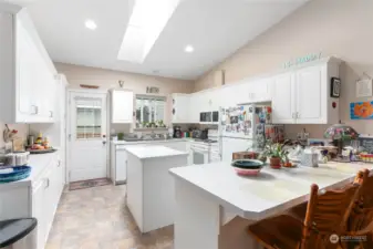 Very large kitchen space with room for three barstools/seats.