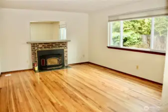 Original hardwoods and fireplace in the living room.