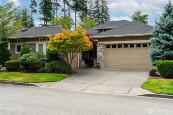 Sought after Hemlock floor plan with clean architectural lines and brick accents, garden walkway leading to covered front porch and mature landscaping