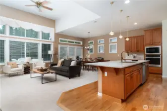 Inviting great room with glass wall and 14' ceilings, illuminating main living areas with natural light