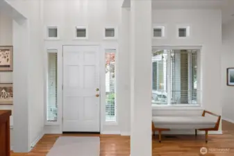 Impressive entrance with two story ceilings and warm, rich hardwood flooring