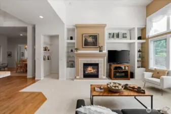 Cozy gas fireplace surrounded with plant ledges and glass shelving, creating a visually stimulating focal point