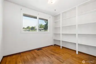 Bedroom #3 with built in storage, large closet and window.