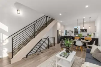 Photos of Model Home. Architectural staircase detail ties the levels together, creating a bold design element that also keeps the interiors airy and connected.