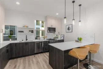 Photos of Model Home. Chef’s kitchen designed for both beauty and function, with sleek cabinetry, quartz countertops, and generous workspace for culinary creativity.