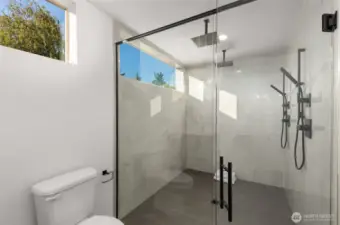 Spa-inspired bath with a frameless walk-in rain shower, polished tile walls, and clean finishes, delivering a daily luxury experience.