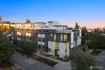 Twilight curb appeal at Arlo, where striking modern architecture meets the charm of Wallingford. The warm exterior finishes glow against the evening sky, welcoming you home.