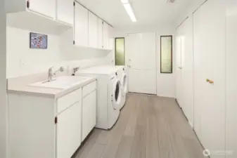 Utility room downstairs includes washer/dryer, extra storage, and second entrance to side yard