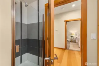 Main floor bathroom has a glass door walk in shower.