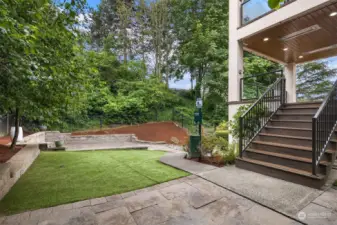 From this deck, one can access the very private backyard which combines turf and multiple patios.