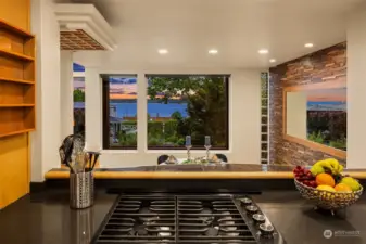 The kitchen opens onto the dining room and the west facing views leading to Puget Sound.