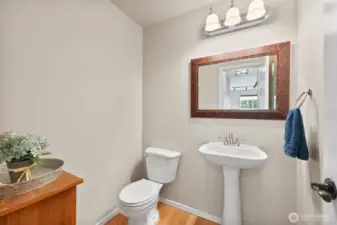 Half bath on main level with pedestal sink.