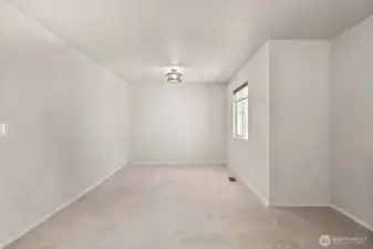 Bonus room on upper level. Photo has been digitally decluttered.