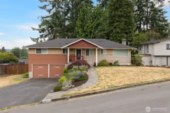 Front of home with two car garage and room for more parking in the driveway. Room for a trailer as well!