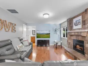 Open family room with custom stone gas fireplace