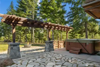 Outdoor patio with hot tub and fire pit