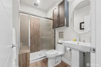 The third bathroom for use so guests don't have to walk through a bedroom to access facilities.  All baths have high-boy elongated toilets, and tile surrounds.