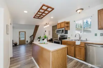 view of kitchen into dining room and back door