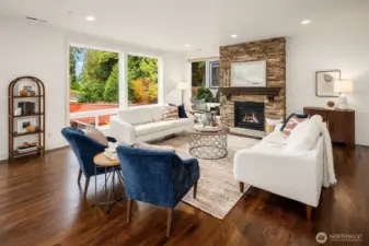 Open living room with light and central fireplace.