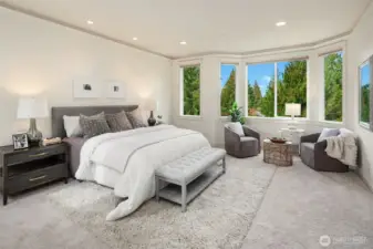 spacious primary with a view out over the backyard and beyond