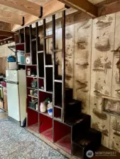 Kitchen and stairs to loft. Wood stove and propane heater.