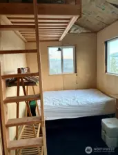 Sleeping area and loft in studio.