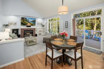 Eating space overlooking cozy family room with gas fireplace