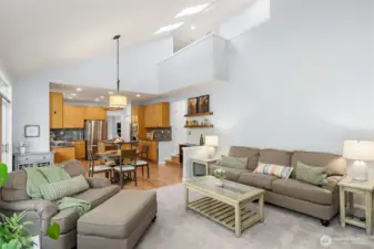 Family room overlooking hallway that leads to laundry room and half bath
