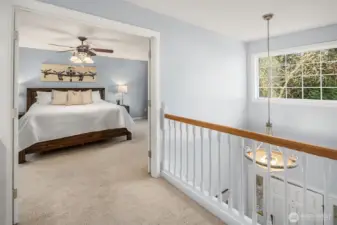 On upper level, french doors lead to spacious primary bedroom