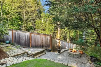 Fire pit area for outdoor entertaining with pathway leading to RV/boat parking