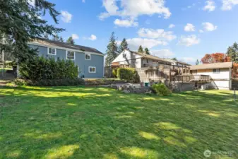 Look at this great, lush yard! And look at the privacy trees between the upper patio and the yard... giving you great entertaining space separate for the yard.