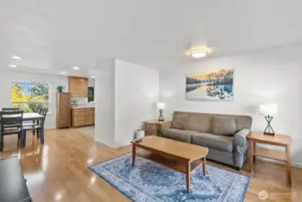 Standing in the upstairs living room, you're looking to the dining and kitchen areas. 2 bedrooms and bathroom to the left.