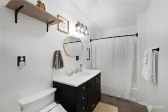 This remodeled bathroom has undergone a complete renovation, featuring new floors, a fresh bath/shower insert, a heated seat bidet, and a fresh coat of paint, creating a modern and inviting space.