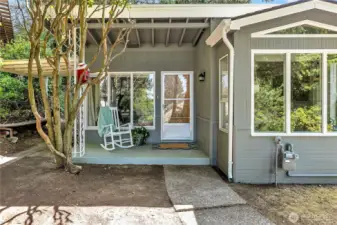 Covered front porch looks out toward the sound and Narrows Bridge.