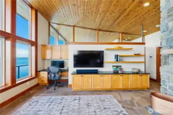 Custom built-ins at end of living room with additional cabinet/storage space and work space.
